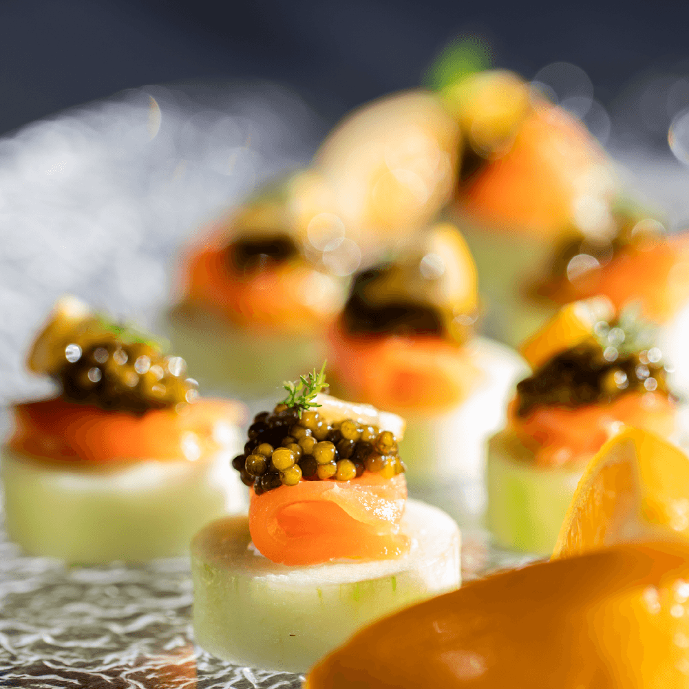 a close up of a plate of food with caviar on top
