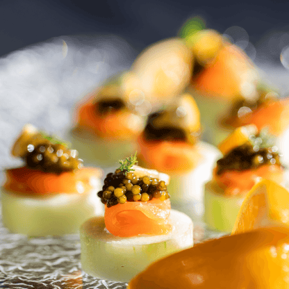 a close up of a plate of food with caviar on top