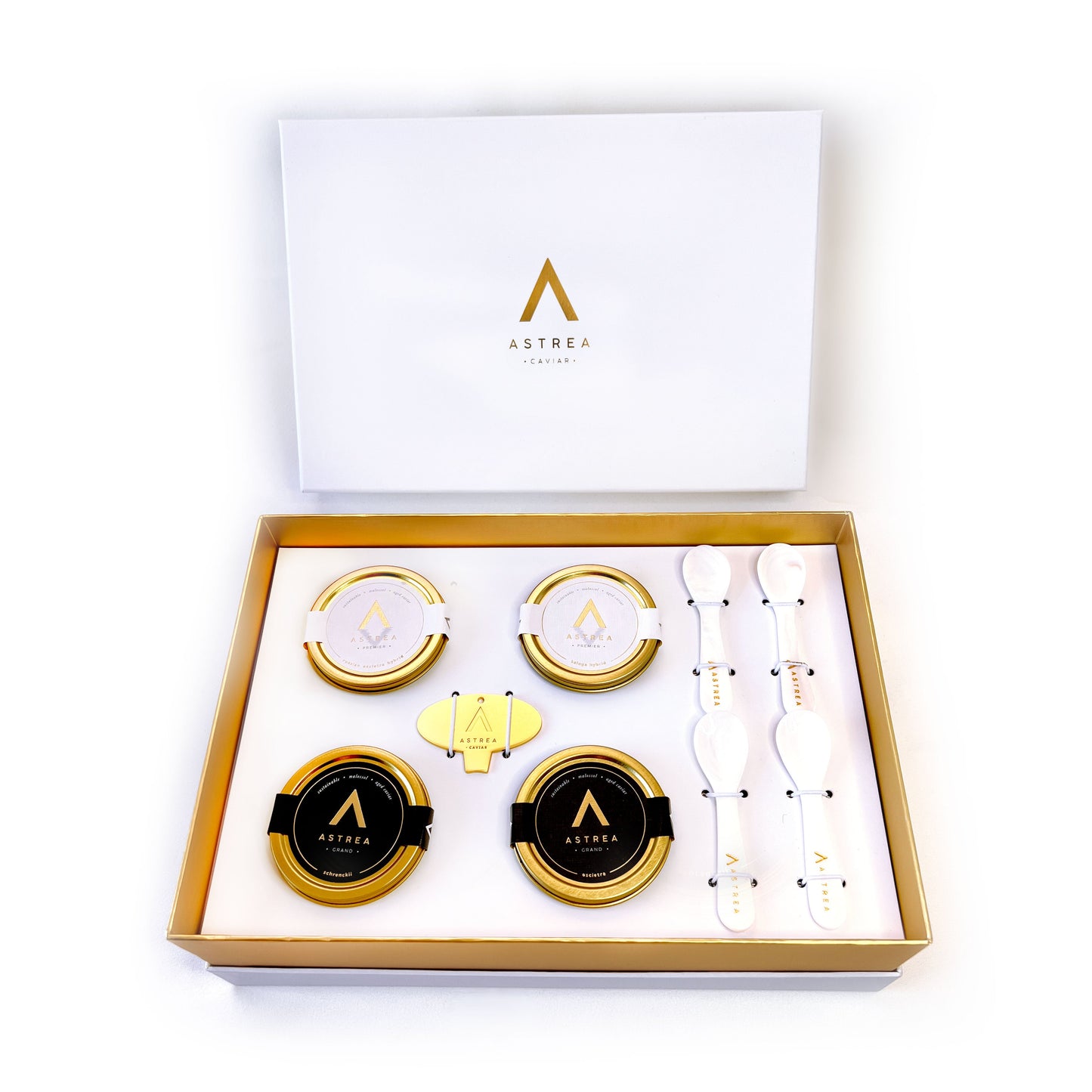 A gift box set including four tins of astrea caviar and four serving spoons