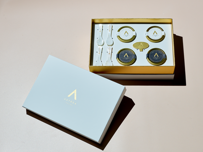a white box including four tins of astrea caviar with the word astrea on it