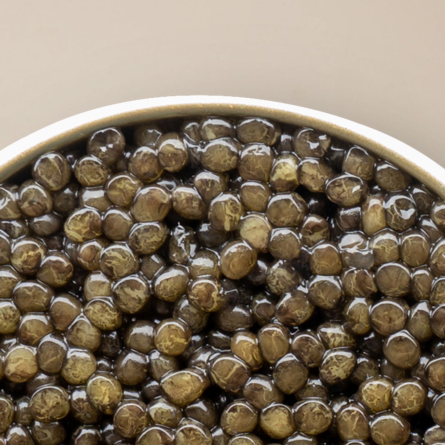 a close up of a bowl of caviar pearls with a white background